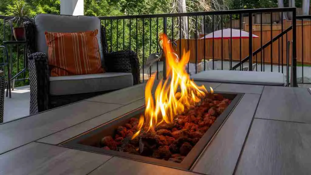 Custom outdoor fire pit installed on a modern patio with cozy seating