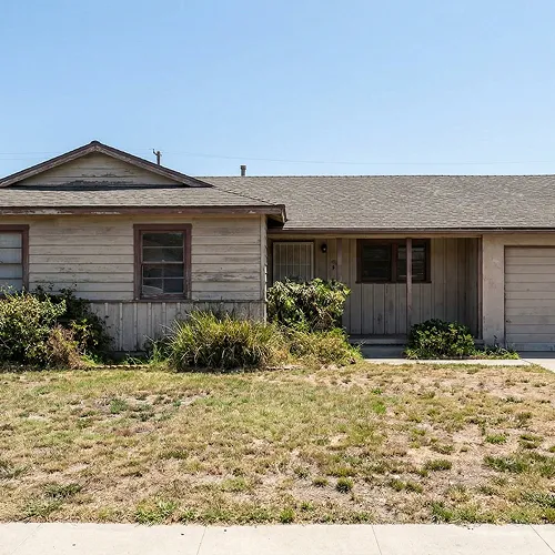 Exterior remodeling by IO Builders Group featuring modern architecture, clean lines, landscaped yard, and indoor-outdoor living design